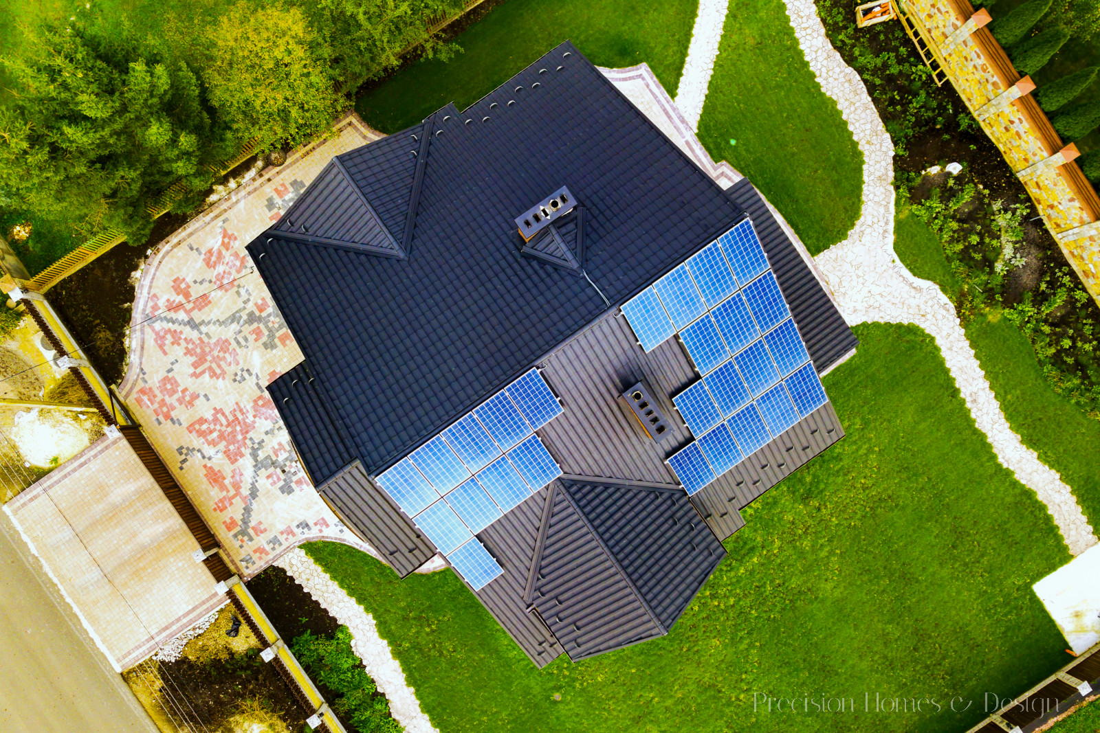 Aerial view of a custom home with solar photovoltaic panels for producing clean electricity on roof. Autonomous home.